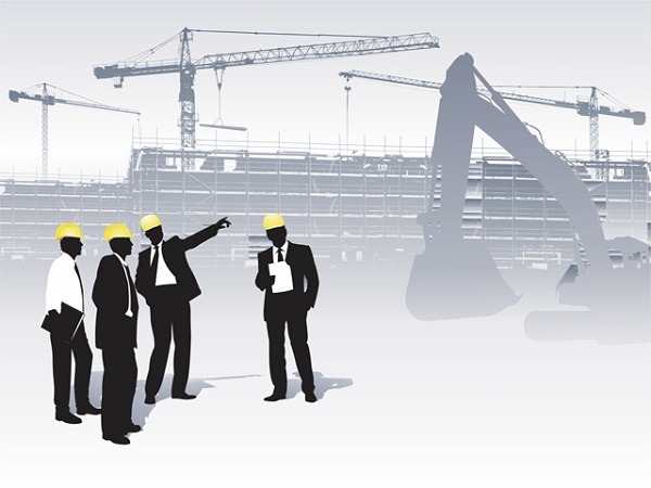 Giám Sát Công Trình Hiệu Quả: Hướng Dẫn Từ A-Z Cho Người Xây Nhà Nhóm kỹ sư thảo luận về giám sát công trình trên bản vẽ